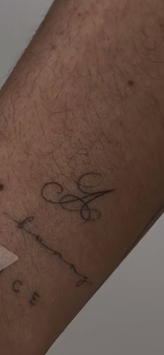 a person with scissors and writing on their arm