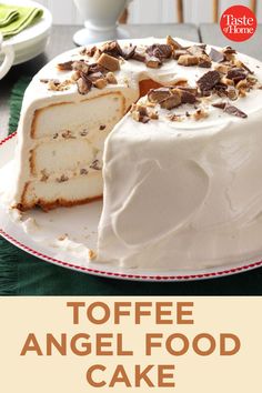 a cake with white frosting and nuts on top