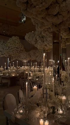 an elegant wedding reception with white flowers and candles