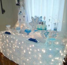 a table topped with lots of blue and white decorations