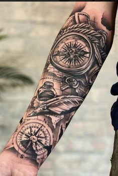 a man's arm with a compass and other things on it, all in black and white