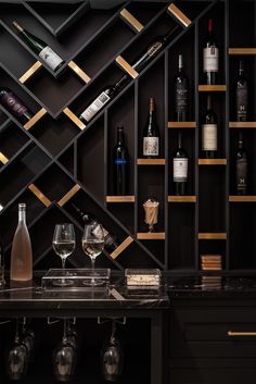 a wine rack filled with lots of bottles and glasses