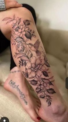 a woman's leg with flowers on it and the words happy birthday written in black ink