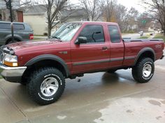 a red pick up truck parked on the street