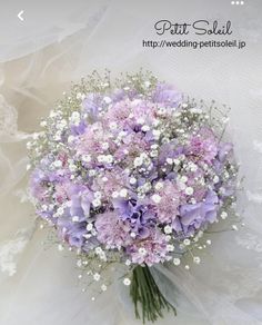 a bridal bouquet with baby's breath flowers on it is shown in front of a white background