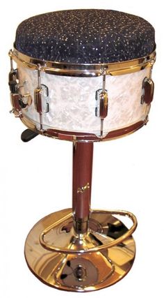 a close up of a drum on a stand with a white and black cover over it