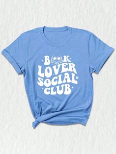 Introducing our exclusive Social Club Bookish T-Shirt, a must-have for all bookworms and avid readers! ✨ Perfect for book club enthusiasts and lovers of literature, this unique design merges style and intellect to create a statement piece for any occasion. Our social club shirt features a captivating illustration that brings together various elements of the bookish world.  The center focuses on a charming library, adorned with piles of books and a cozy reading chair. Surrounding it, adorable emojis depict the joy of reading, expressing your love for books without saying a word! ❤️ For those who are passionate about banned books or appreciate literary rebellions, this shirt showcases a subtle nod with a red "BANNED" stamp, adding an extra edge to your wardrobe.  Designed with comfort in min Bookish Shirt Designs, Book Club Shirt, Belles Book Club Shirt, Bookish Graphic Print T-shirt For Summer, Cozy Reading Chair, Summer Bookish T-shirt With Graphic Print, Bookworm Shirt, Happy Shirt, Librarian Shirt