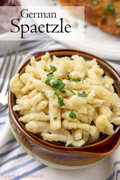 a bowl filled with macaroni and cheese on top of a blue and white table cloth