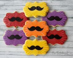 decorated cookies with mustaches on them are arranged in the shape of fanned fans