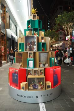 a display in the middle of a shopping mall filled with boxes and other items that are stacked on top of each other