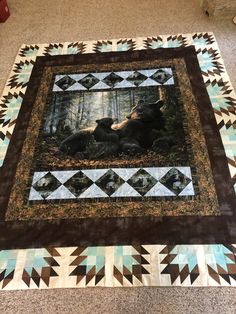 a quilted photo of two bears in the woods