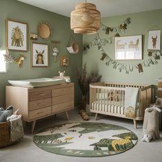 a baby's room with green walls and pictures on the wall