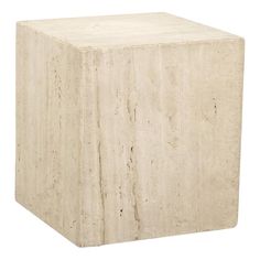 a square stone block sitting on top of a white floor