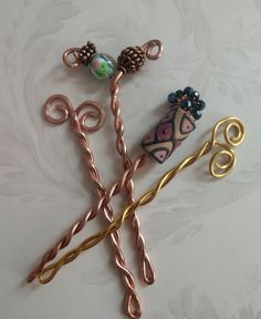 I came upon the idea of Shawl Stick Pins, when I couldn't figure out how to keep my shawls on the hangers at craft fairs.  I wanted to show my shawls, but they looked silly just draped on the tables.  This little idea saved the day, and helped me to sell several shawls, not to mention a bunch of shawl pins! These are unique, because the stick portion is twisted, so doesn't have a sharp edge that could stick your body.  The idea is that they are used with open weave shawls or cowls or scarves.  They work like a charm and hold the pieces perfectly in place. I have created several with all different lengths and bead tops.  You will see how lovely they are, and how well they complete the knitted and crocheted items. Also, for those ladies who have long hair, they can be used as hairpins to hol Hairpin Crochet, Woven Shawls, Bead Hair, French Twist Hair, Girl Scout Leader, Shawl Pin, Crocheted Items, Artisan Gift, Shawl Pins