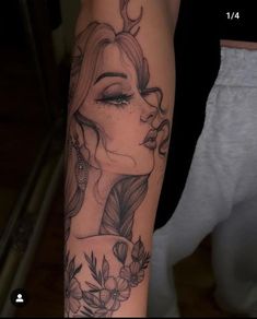 a woman's face with flowers and leaves on her arm is shown in this tattoo design