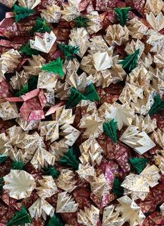 many different types of origami pieces are arranged in the shape of christmas trees