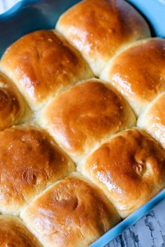 a blue baking dish filled with hot cross buns