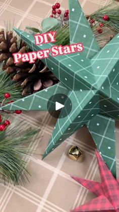 an origami christmas star next to pine cones and other holiday decorations with the words diy paper stars