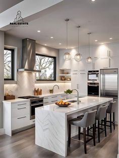 a modern kitchen with marble counter tops and stainless steel appliances, along with an island in the middle