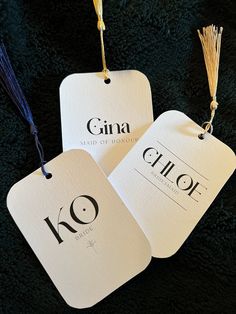 two tags with the name gina and chope written on them hanging from strings