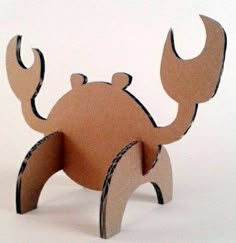 an animal made out of cardboard on a white surface