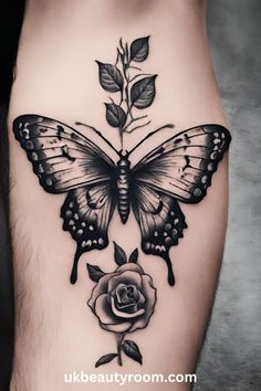 a butterfly and rose tattoo on the side of a woman's thigh with black ink