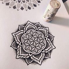 a pen and ink drawing on paper with an image of a flower of life