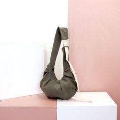 "The Moon Shaped Ruffled Bag is a unique bag, which comes in two sizes: Medium & Large. It is easily carried both as a shoulder bag and as a cross body bag by simply adjusting the buckle on the strap. The ruffles of the bag create the bag's volume and body, giving it also a special looking design. The medium sized bag can contain your everyday belongings, as the Larger bag can carry even more. The bag is called \"moon-shaped\" since it is designed in the shape of a crescent moon, which allows th Khaki Rectangular Hobo Bag With Adjustable Strap, Rectangular Khaki Hobo Bag With Adjustable Strap, Khaki Pouch Shoulder Bag With Removable Pouch, Khaki Shoulder Bag With Removable Pouch, Khaki Hobo Shoulder Bag With Adjustable Strap, Khaki Softback Shoulder Bag For Everyday, Everyday Use Khaki Softback Shoulder Bag, Khaki Hobo Shoulder Bag With Removable Pouch, Reversible Canvas Shoulder Bag