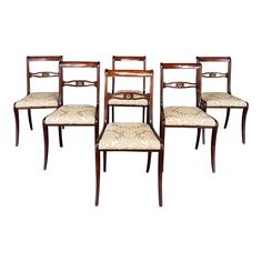 set of four mahogany dining chairs with upholstered backrests and seat cushions