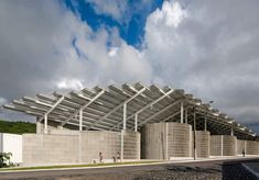 a large building that has some kind of structure on top of it with people walking around