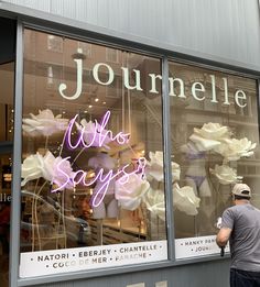 a man standing in front of a store window