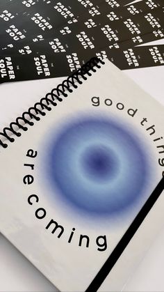 three spiral notebooks with the words good things coming written in black and white on them