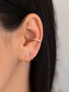 "An all-time bestseller with lilac cubic zirconia stones. Elegant and classic, these tiny huggie hoops prong-set with brilliant zirconia gemstones are a beautifully dainty addition to your everyday lineup. Subtle, versatile and perfect to mix and match with other earrings. ∙ This listing is for the pavé lilac huggie hoops (as seen on the model's second piercing). ∙ Sold individually (1 hoop) or by pair (2 hoops). * D E T A I L S * ∙ Material: .925 Sterling Silver or 18K Gold Plated over .925 Ste Trendy Purple Small Hoop Jewelry, Purple Minimalist Earrings For Pierced Ears, Purple Earring Stack, Elegant Purple Small Hoop Earrings, Purple Amethyst Earrings For Pierced Ears, Aesthetic Piercings, Earring Stacks, Earrings Small Hoop, Earring Piercing