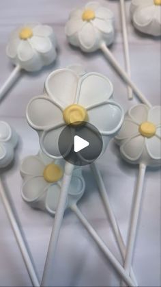 several white and yellow flower shaped lollipop sticks