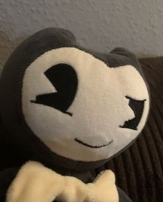 a black and white stuffed animal with a bow tie