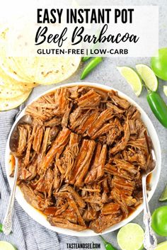 easy instant pot beef barbacoa in a white bowl with lime wedges