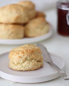 biscuits on a plate with a glass of jam in the background