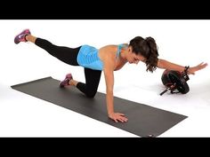 a woman is doing an exercise on a mat