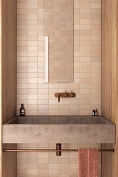 a bathroom sink sitting under a mirror next to a towel rack and wooden cabinet in front of it