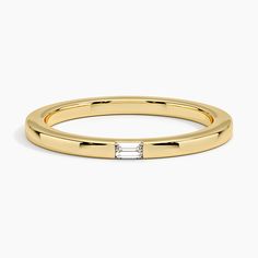 a yellow gold band with a baguettte diamond set in the middle, on a white background