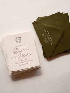 wedding stationery and envelopes laid out on a table