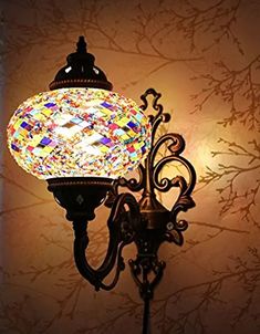 a wall light with a colorful glass ball on it