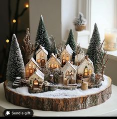 a small christmas village with trees and lights