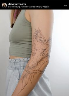 a woman with a dragon tattoo on her arm