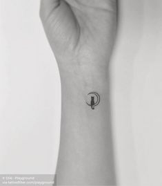 a person's wrist with a small tattoo on it