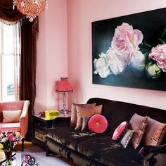 a living room filled with furniture and a painting on the wall