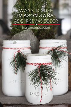 three mason jars decorated with pine needles and twine tied around the lids are sitting on a table