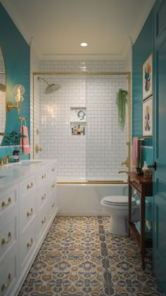 a bathroom with blue walls and white cabinets