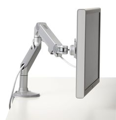 a computer monitor with a light on it's arm and the screen is turned on