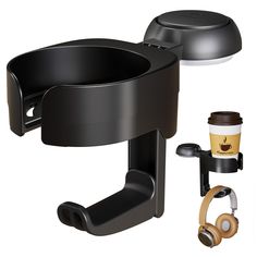 there is a cup holder with headphones on it and a coffee mug next to it